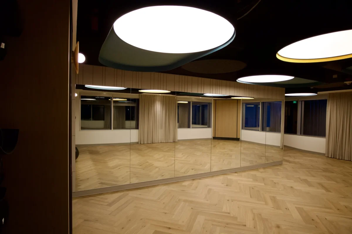Interior glazing at 1201 NW 3rd: black-framed glass doors, partitions and mirrors on the building amenity floor.