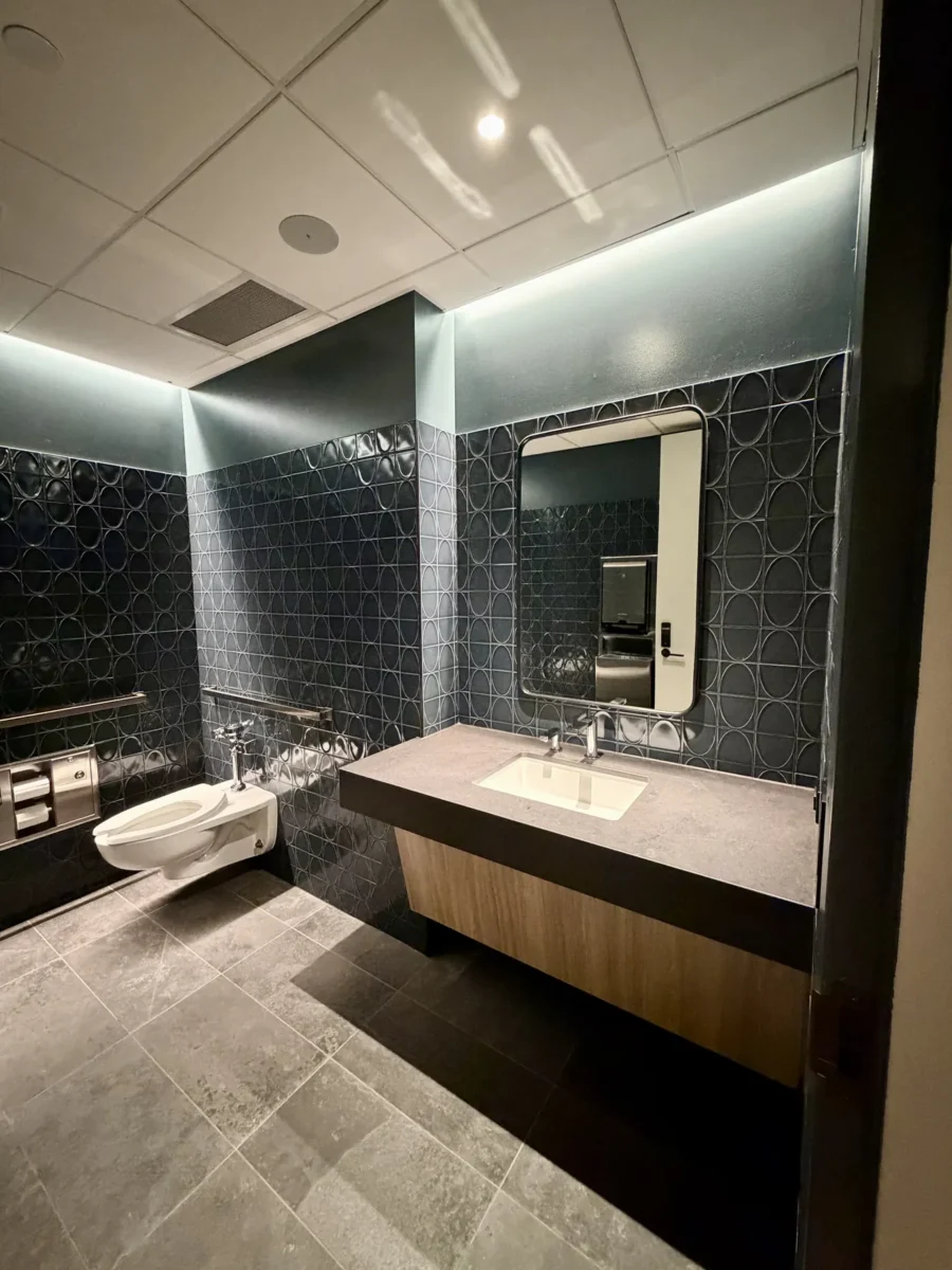 Interior glazing at 1201 NW 3rd: black-framed glass doors, partitions and mirrors on the building amenity floor.