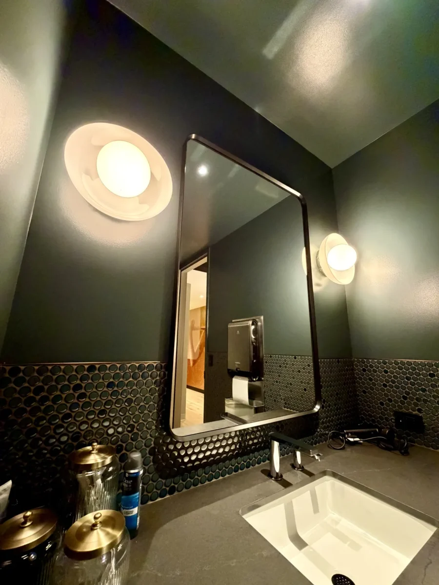 Interior glazing at 1201 NW 3rd: black-framed glass doors, partitions and mirrors on the building amenity floor.