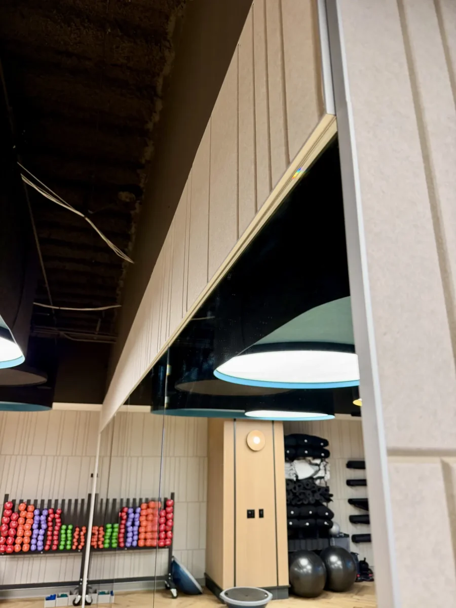 Interior glazing at 1201 NW 3rd: black-framed glass doors, partitions and mirrors on the building amenity floor.