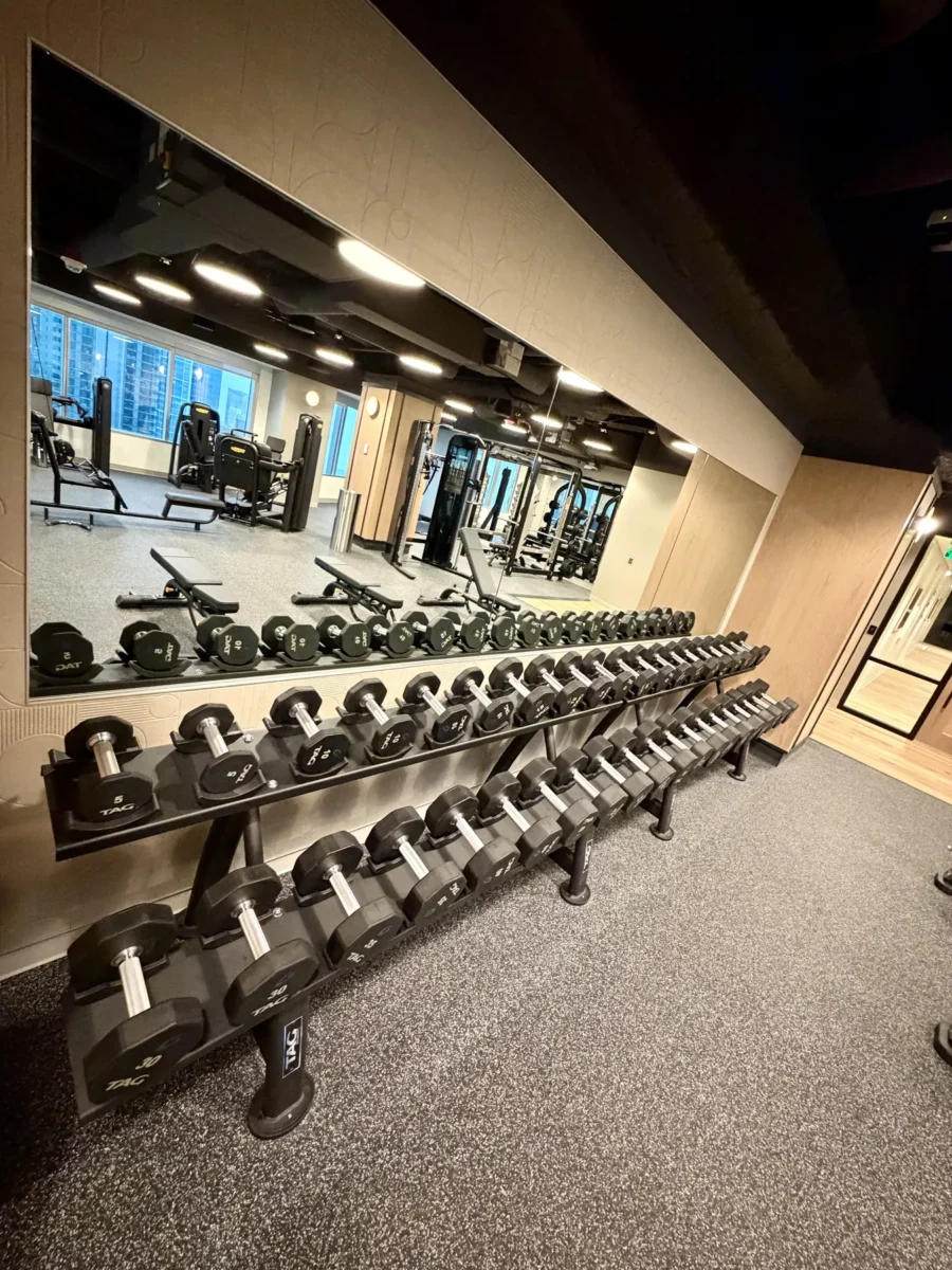 Interior glazing at 1201 NW 3rd: black-framed glass doors, partitions and mirrors on the building amenity floor.
