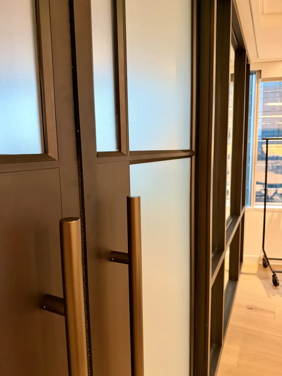 Interior glazing at 1201 NW 3rd: black-framed glass doors, partitions and mirrors on the building amenity floor.