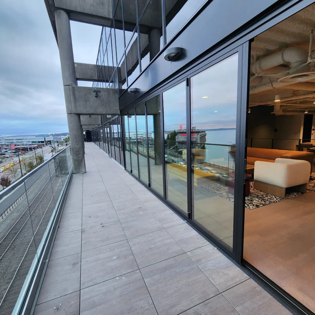 Curtain wall and glazed elevations at 2323 Elliott, with a terrace looking out over the water.