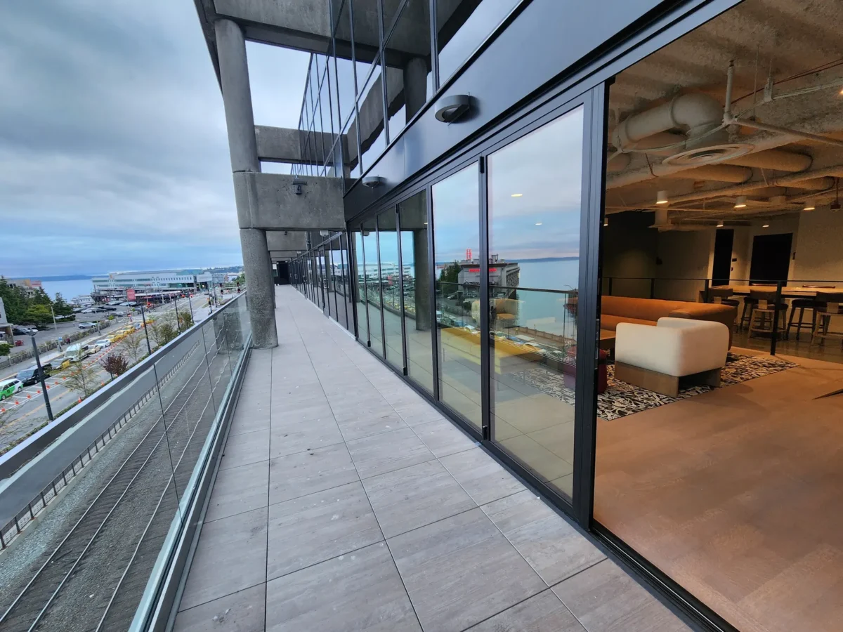 Curtain wall and glazed elevations at 2323 Elliott, with a terrace looking out over the water.