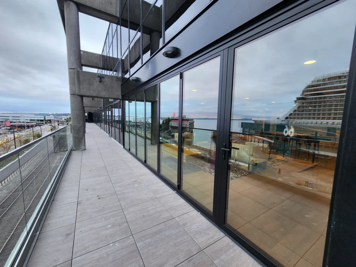 Curtain wall and glazed elevations at 2323 Elliott, with a terrace looking out over the water.