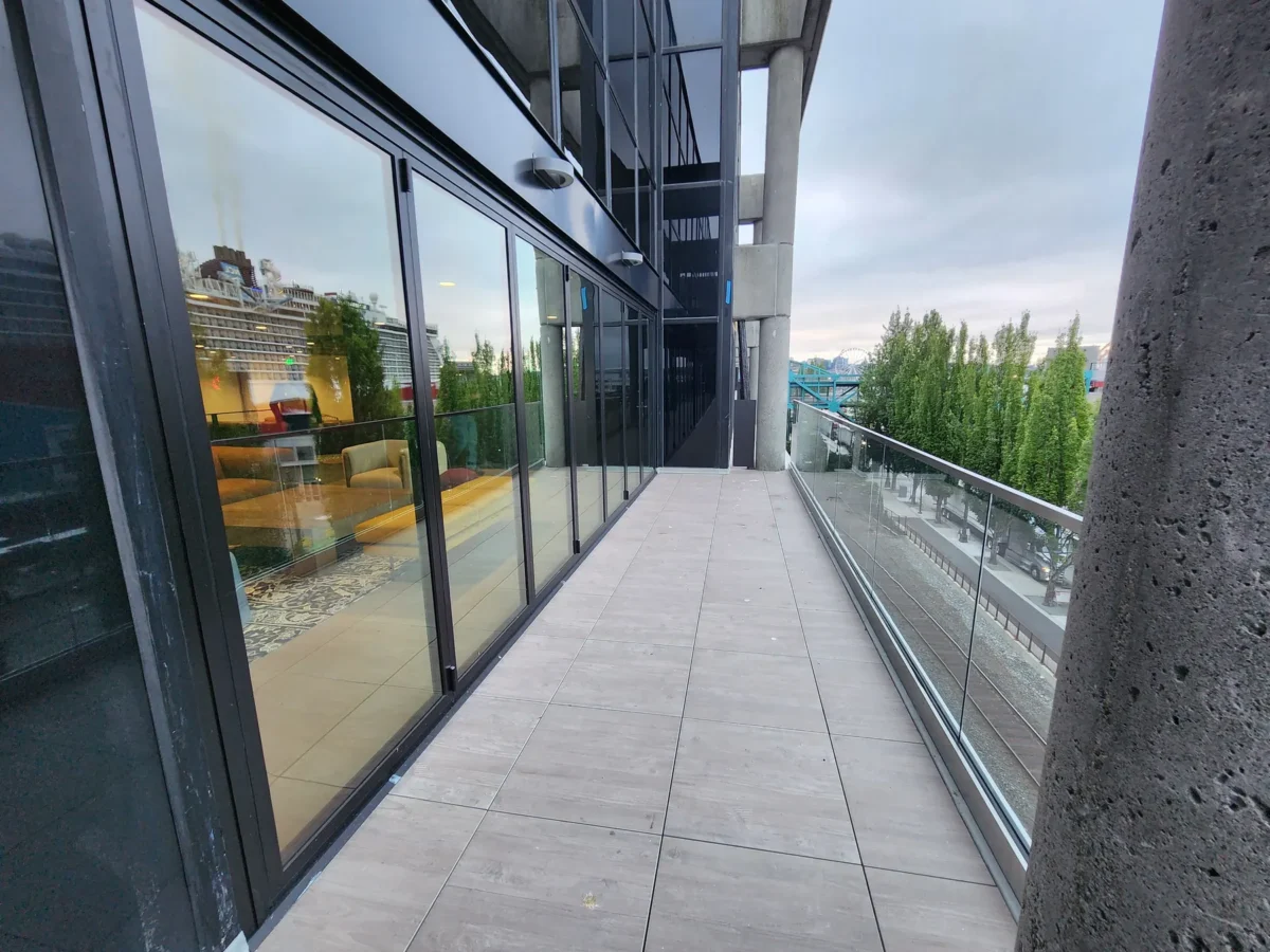 Curtain wall and glazed elevations at 2323 Elliott, with a terrace looking out over the water.