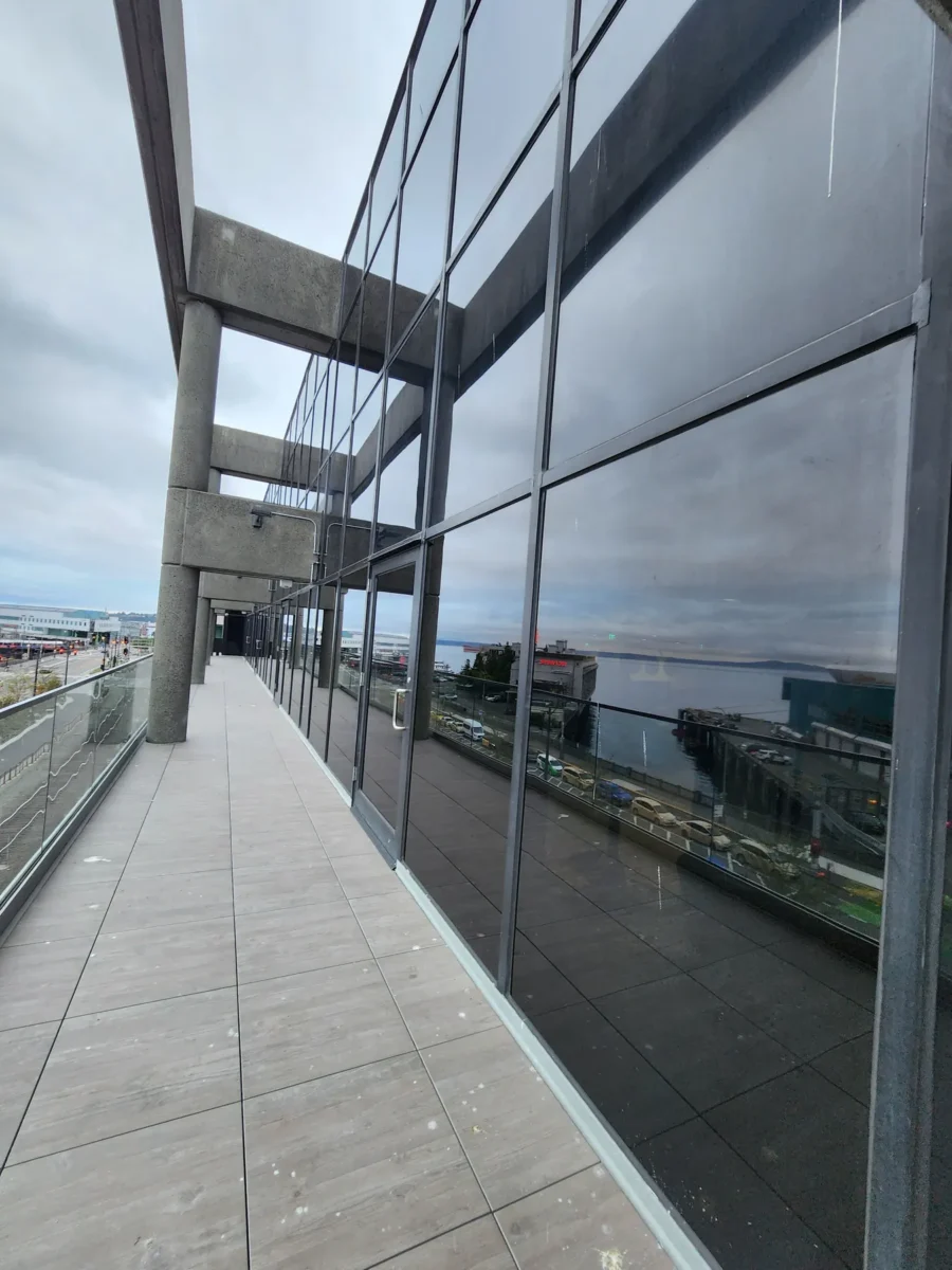 Curtain wall and glazed elevations at 2323 Elliott, with a terrace looking out over the water.
