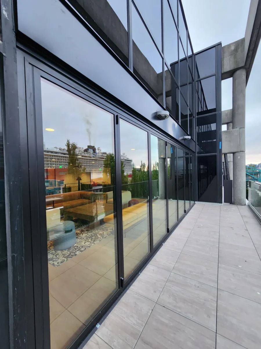 Curtain wall and glazed elevations at 2323 Elliott, with a terrace looking out over the water.