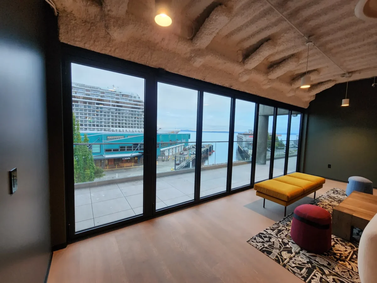 Curtain wall and glazed elevations at 2323 Elliott, with a terrace looking out over the water.