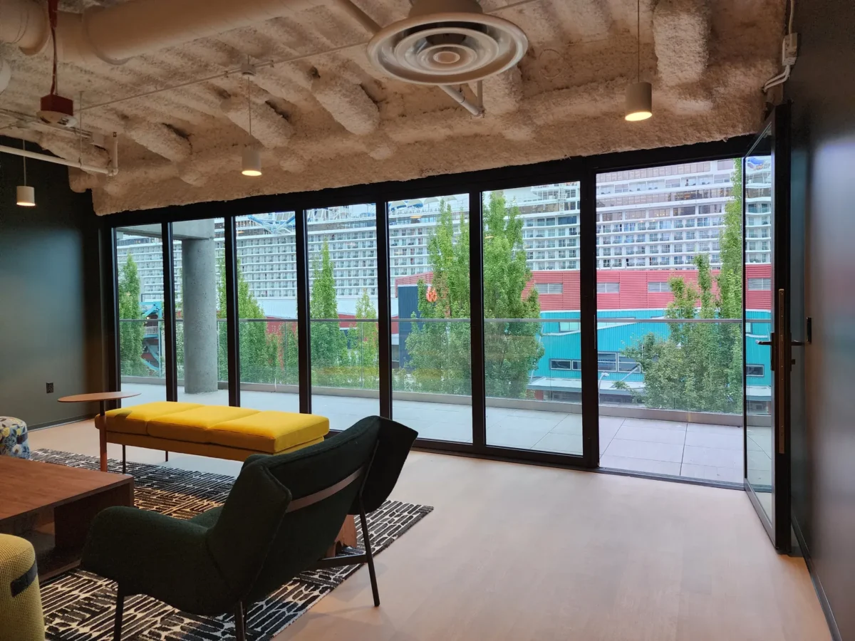 Curtain wall and glazed elevations at 2323 Elliott, with a terrace looking out over the water.