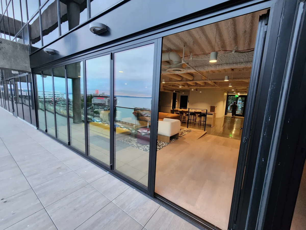 Curtain wall and glazed elevations at 2323 Elliott, with a terrace looking out over the water.