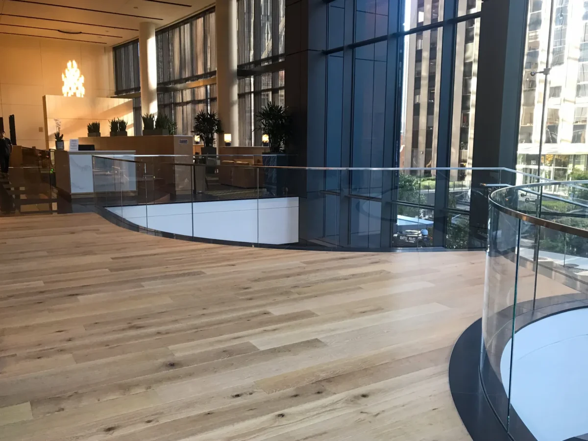 A curved glass stair rail in the lobby at 5th and Madison.