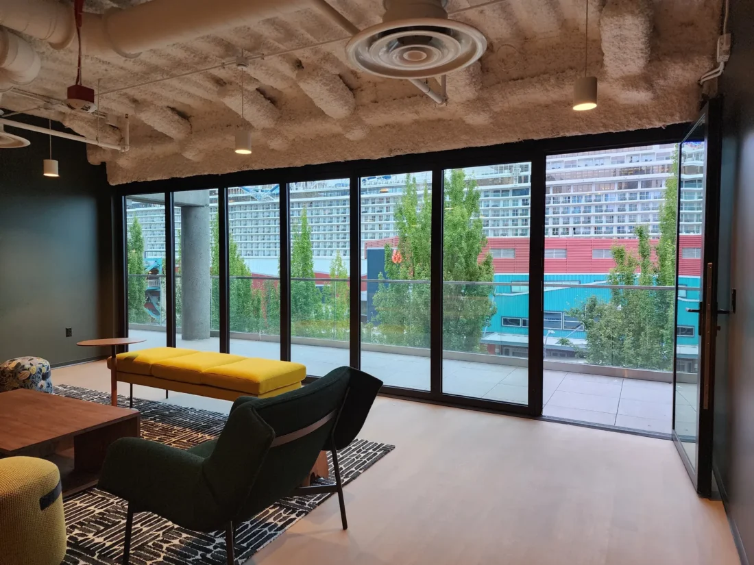 Full-height glazing in a waterfront office lounge at 2323 Elliott