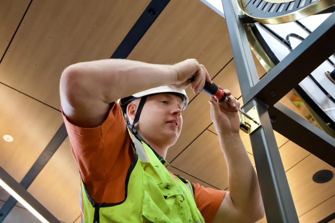 Glazier adjusting glass hardware on the Colman Clock Tower