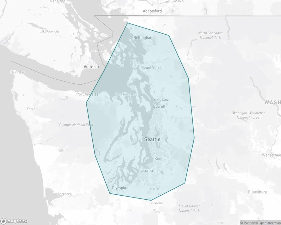 Map of western Washington with the Herzog Glass service area shaded, reaching from Olympia north to Bellingham and from the Olympic and Kitsap peninsulas east to the Cascade foothills.