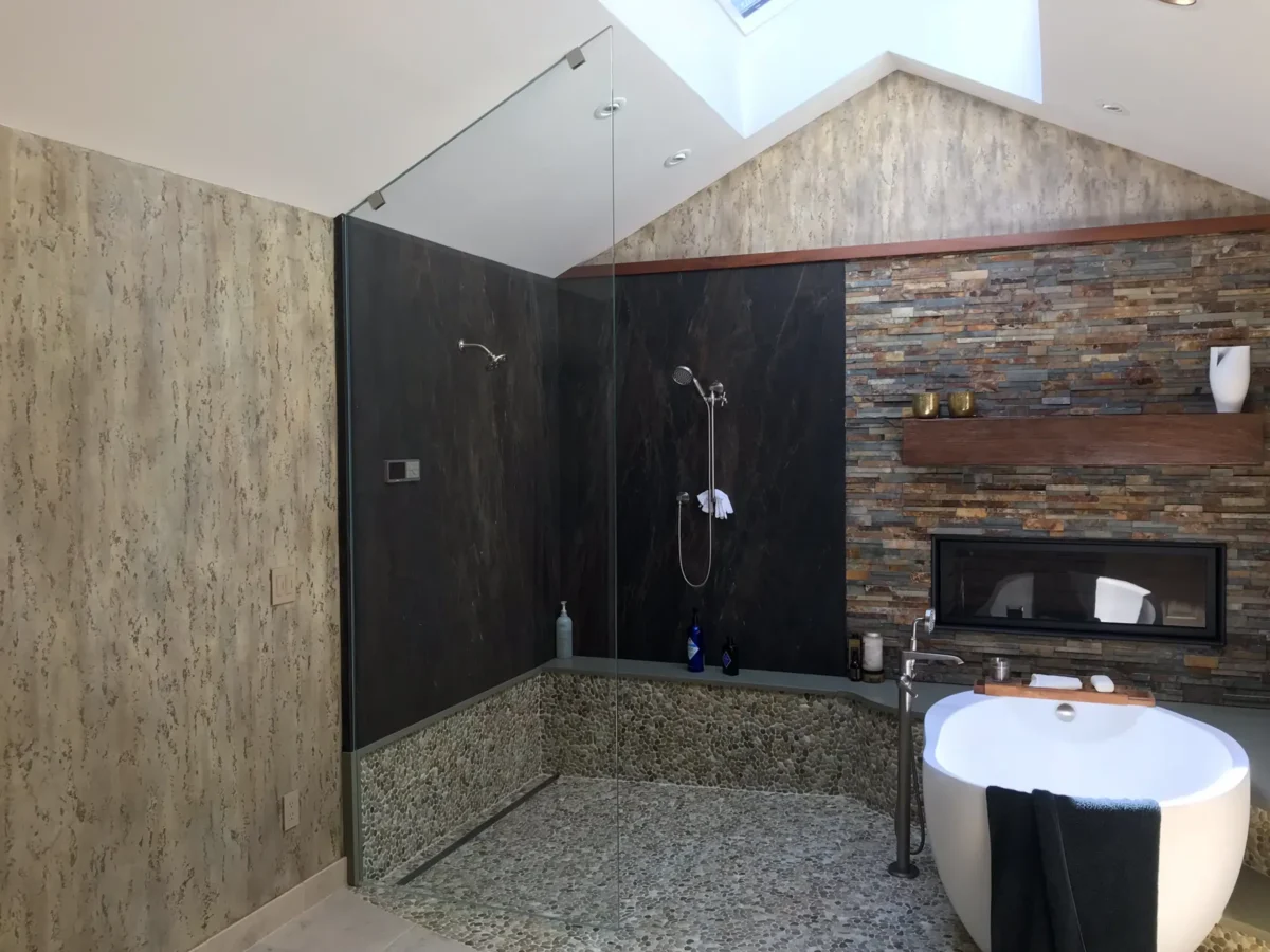 A frameless glass shower enclosure in a tiled bathroom.