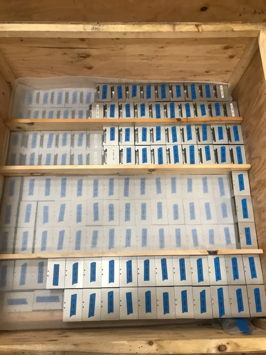 A crate of Space Needle glass panels separated by spacers, ready to ship