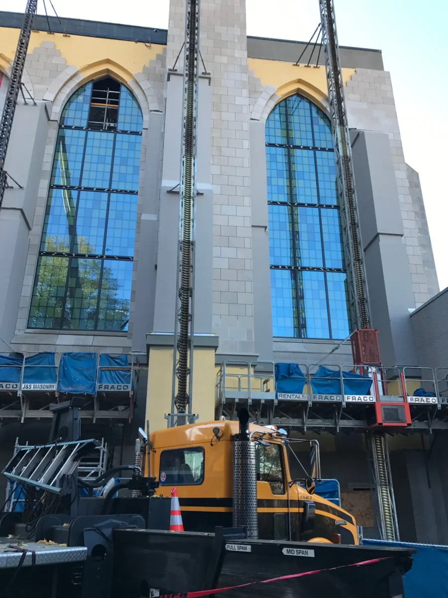 Colored glass panels in the arched windows of St Mark’s Cathedral, and the same panels on the shop floor before installation.