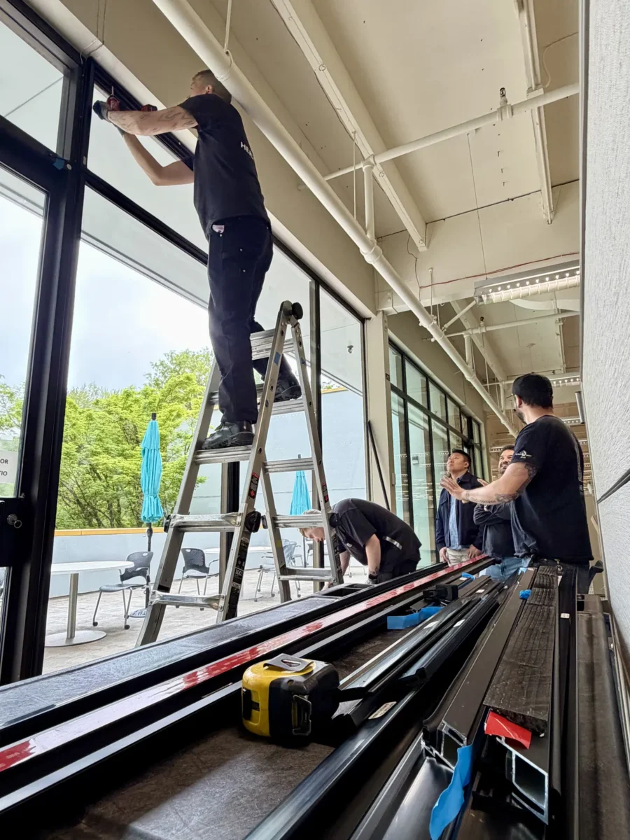 Window and curtain wall work at the Stryker building, with glazed elevations looking onto the trees outside.