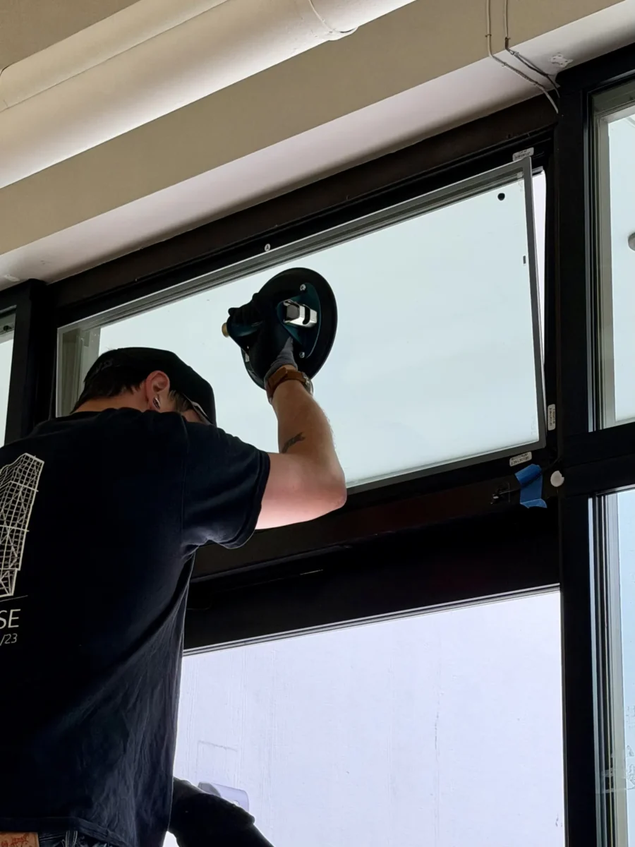 Window and curtain wall work at the Stryker building, with glazed elevations looking onto the trees outside.